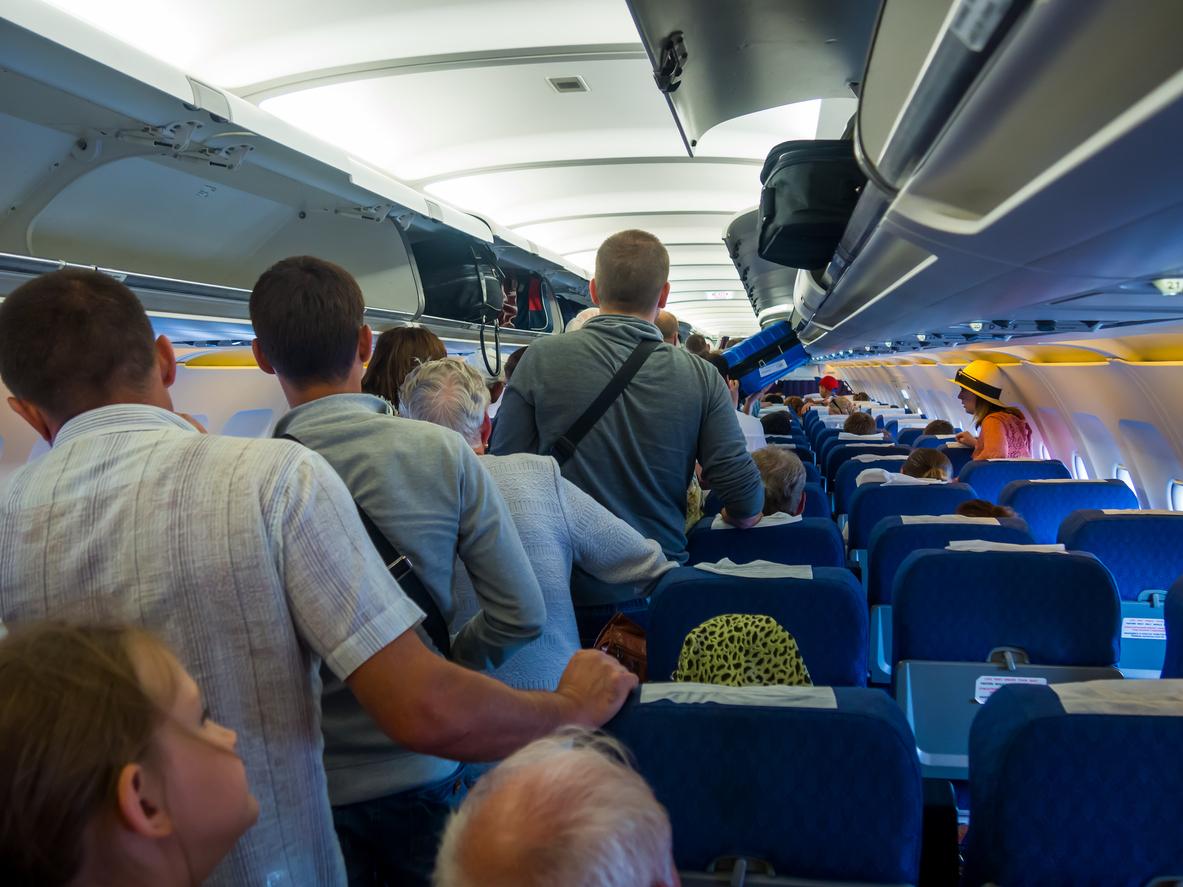 People waiting to exit airplane