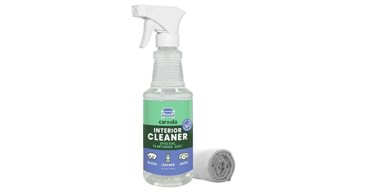 Bottle of car window cleaner with rolled up rag