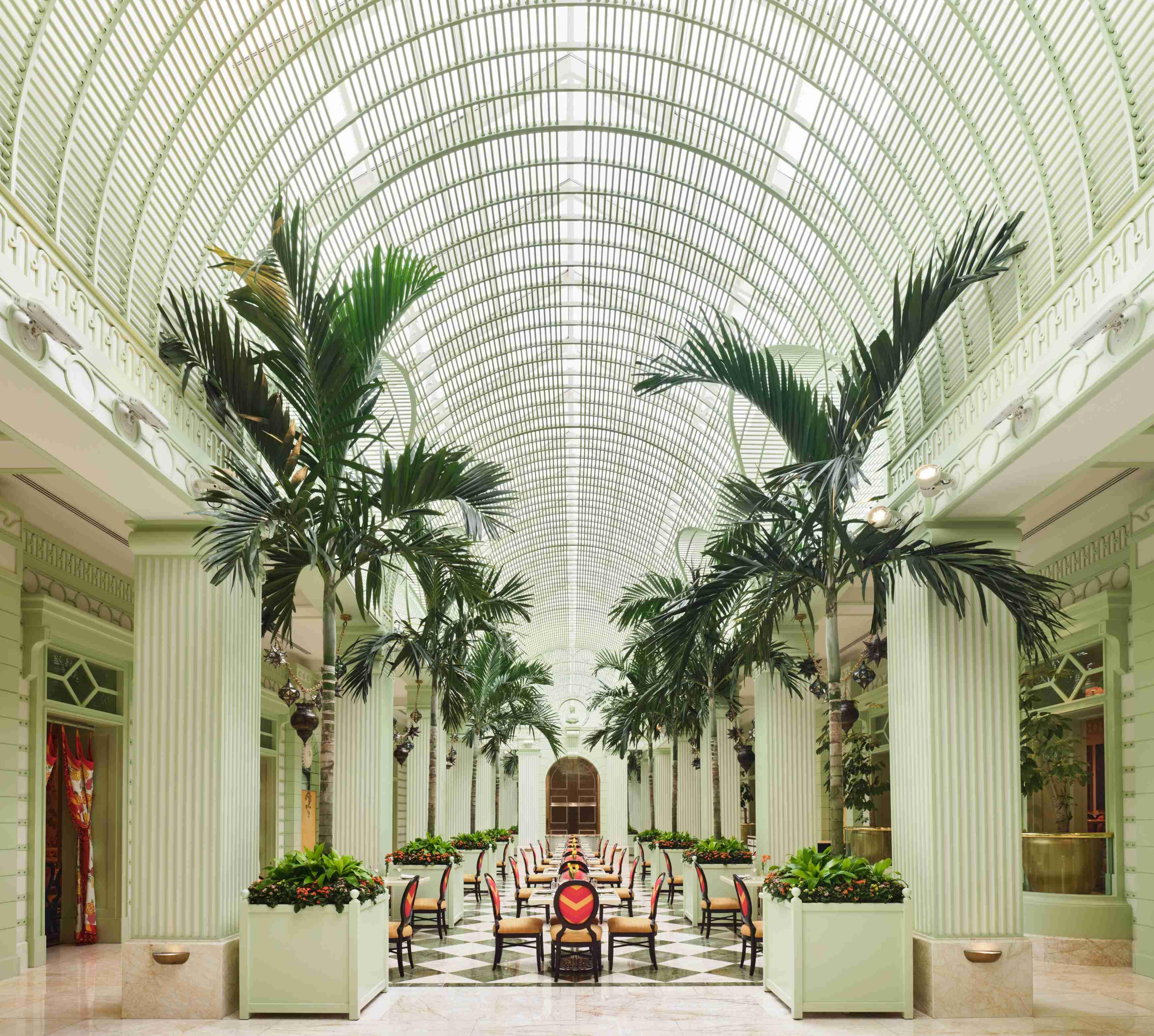 The top half of the entryway to The Buffet is pictured, with trees and green striped columns.