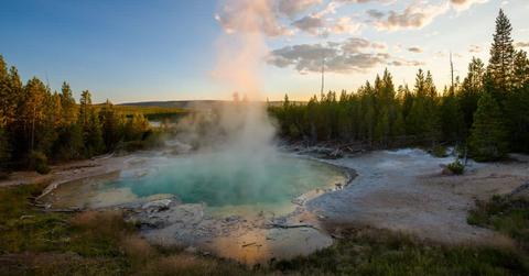 Billowing plume of steam rising from the Norris hot spring in Yellowstone (Cover Image Source: Getty Images | Putt Sakdhnagool)