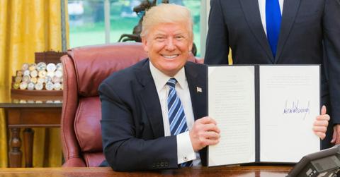 Donald Trump holds a signed executive order