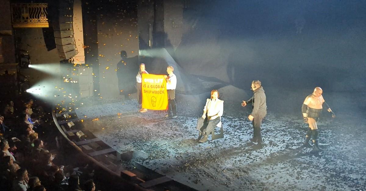 Two protesters take the stage as Sigourney Weaver performs The Tempast