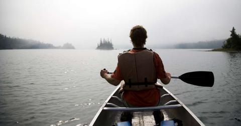 A person paddling in the waters while sitting in a canoe. (Representative Cover Image Source: Getty Images | Per Breiehagen)