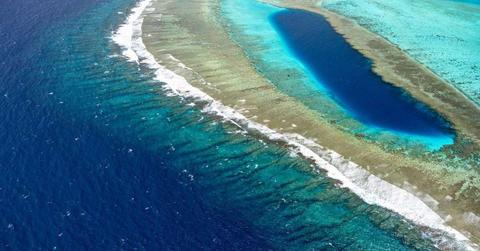 An aerial view of a coastline with a blob of water within the land area. (Representative Cover Image Source: Pixabay | XiSerge)
