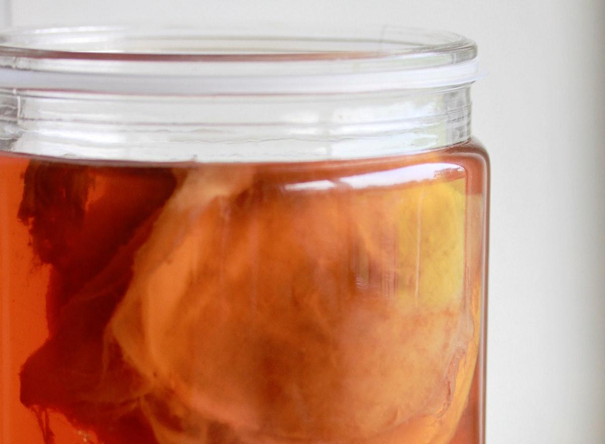 Kombucha steeping in a jar