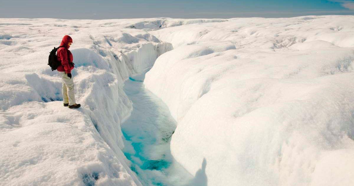 A man looking at a meltwater lake in the polar region. (Representative Cover Image Source: Getty Images | Ashley Cooper)