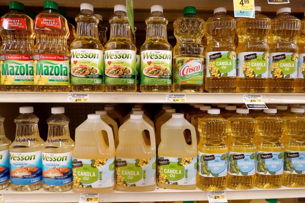 Bottles of canola oil on store shelf