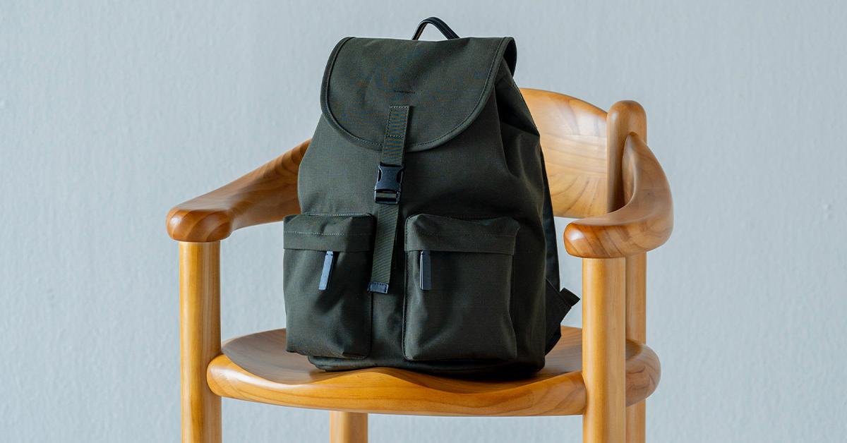 Sandqvist black backpack on a wooden chair