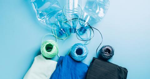 Photo of plastic water bottles, twine, and polyester fabric in front of a light blue background