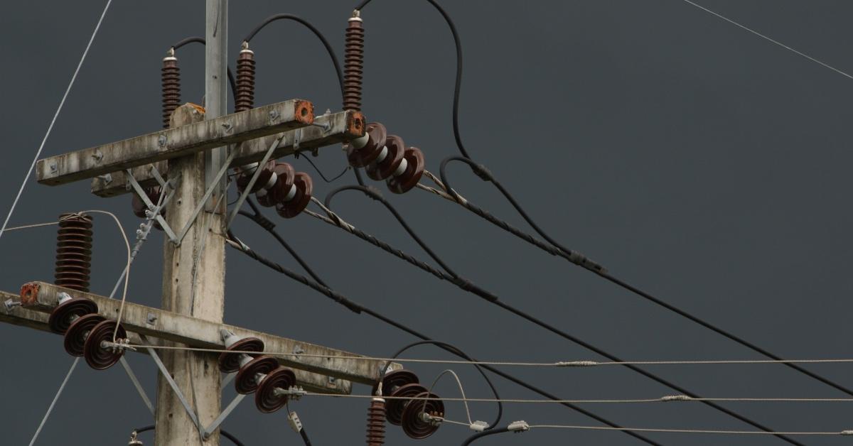 Photograph of a telephone pull with power lines in a blackout.