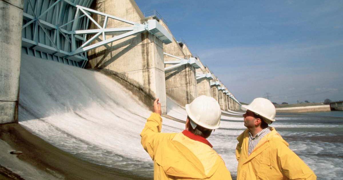 Two construction workers inspecting a dam. (Representative Cover Image Source: Getty Images | William Taufic)