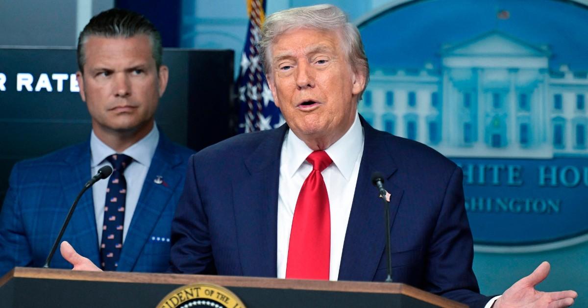 Donald Trump answers questions from behind a podium 