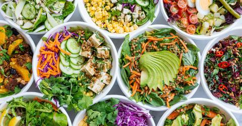 A bunch of different salads are clustered together