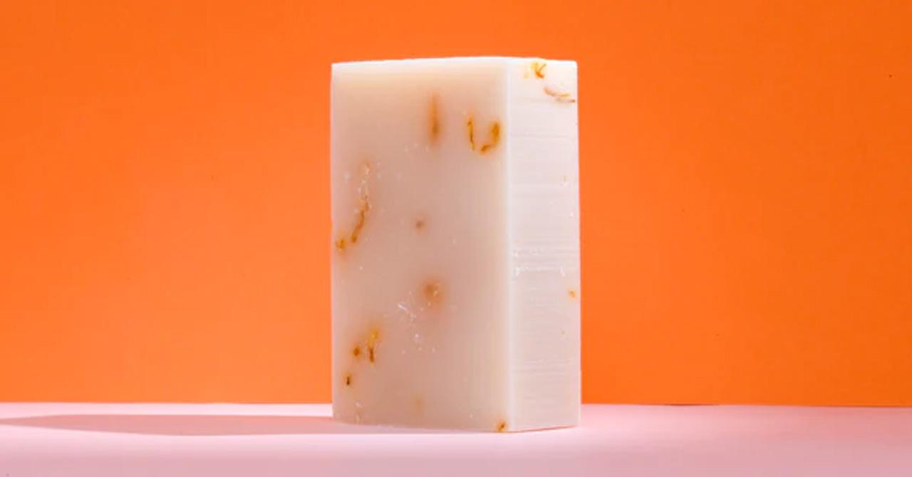 Organic body soap bar on an orange background