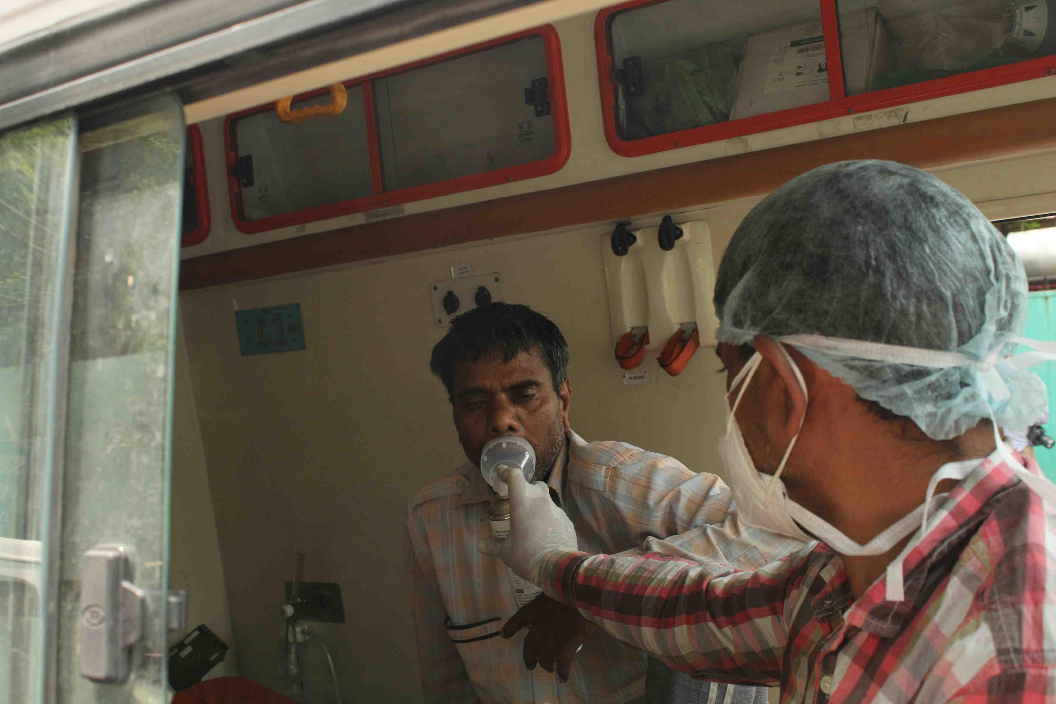 A man in Delhi, India, is given oxygen in an ambulance.
