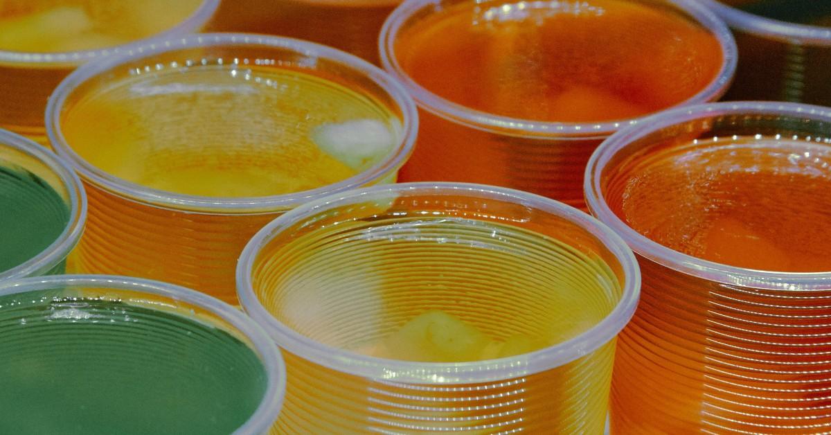 A line of brightly colored Jell-O cups in green, yellow, and orange