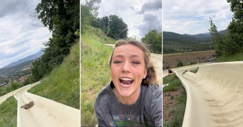 Badger on alpine slide and woman smiling