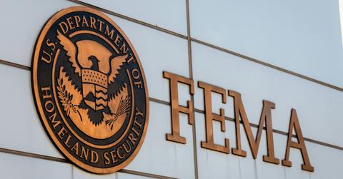 Signage hangs on the side of the building that houses FEMA workers