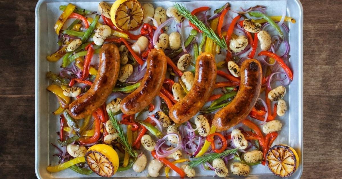 Tray of lab-grown sausage and vegetables roasted in the oven. 