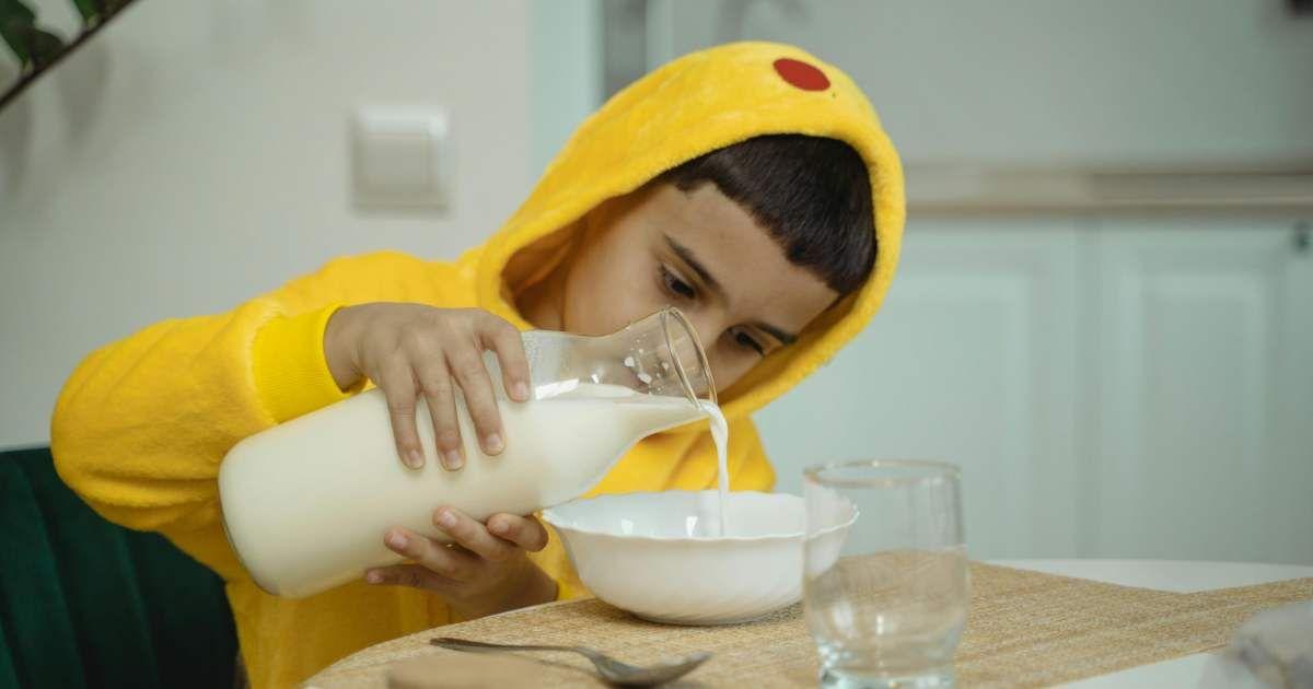 A little boy is pouring milk from a bottle into a bowl. (Representative Cover Image Source: Pexels | Tima Miroshnichenko)