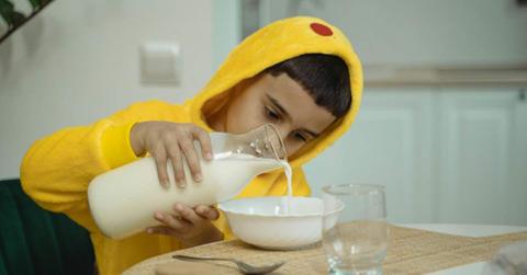 A little boy is pouring milk from a bottle into a bowl. (Representative Cover Image Source: Pexels | Tima Miroshnichenko)