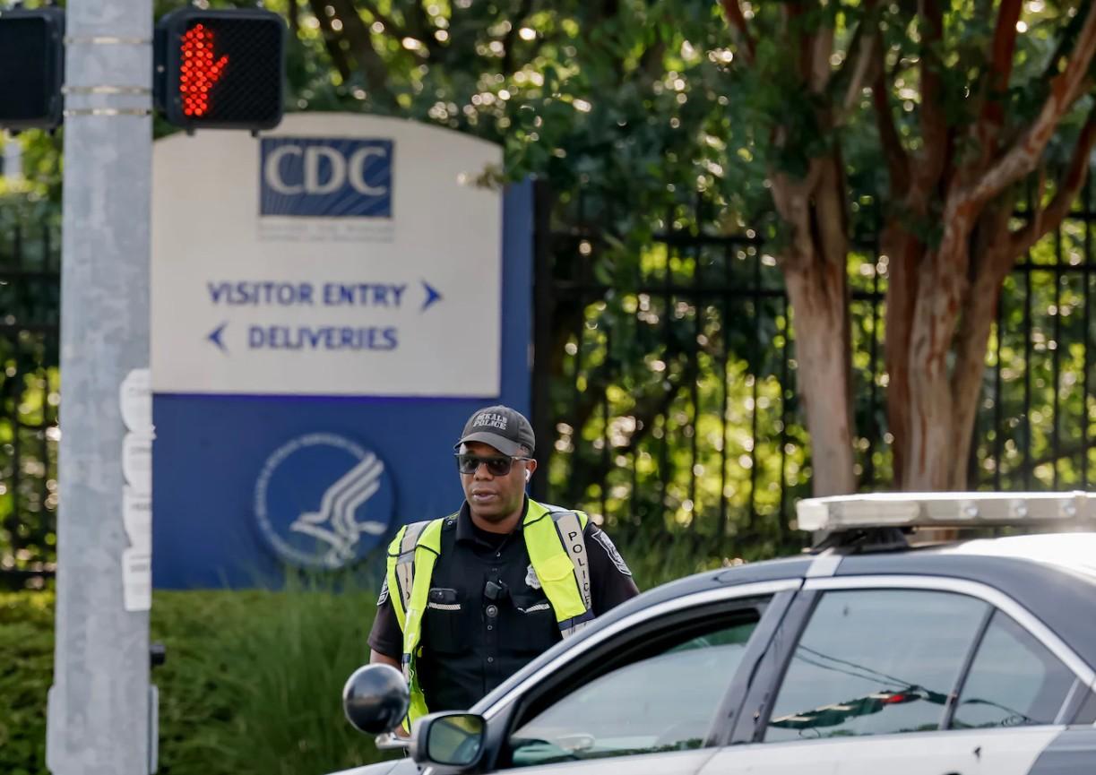 A police officer is pictured standing in front of the CDC headquarters in Georgia.