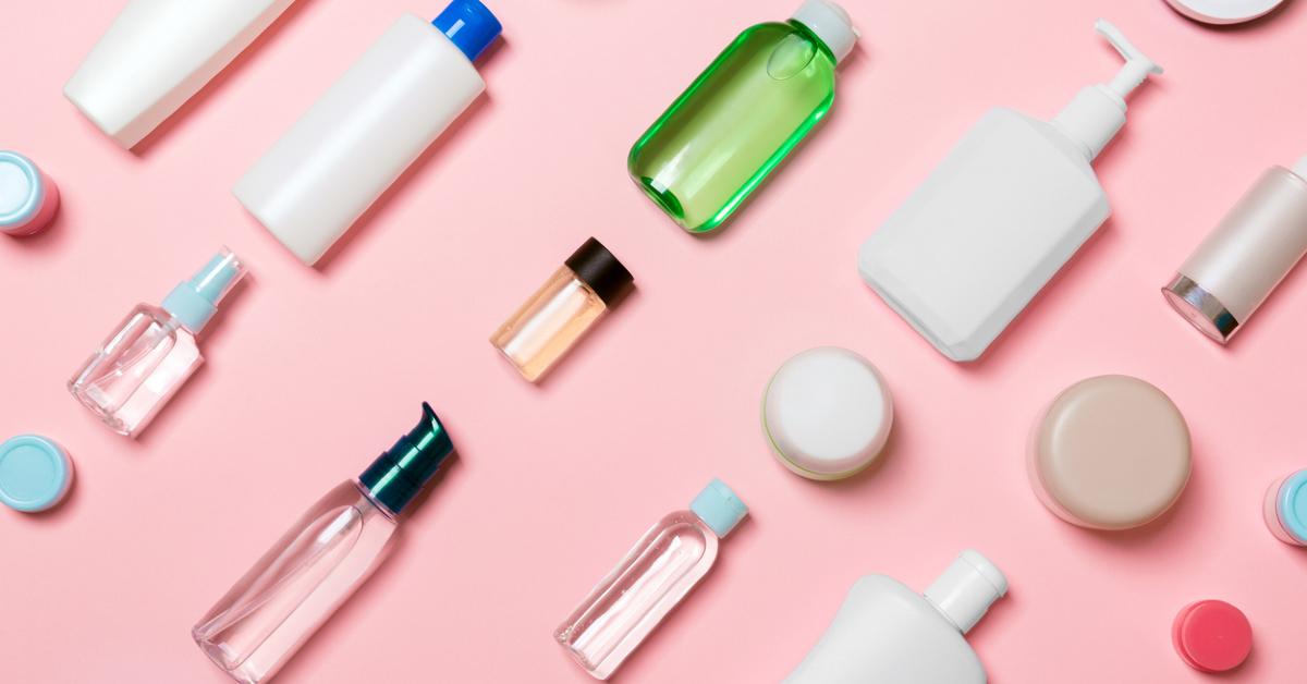 photo of various cosmetic packaging bottles and jars across a solid baby pink background