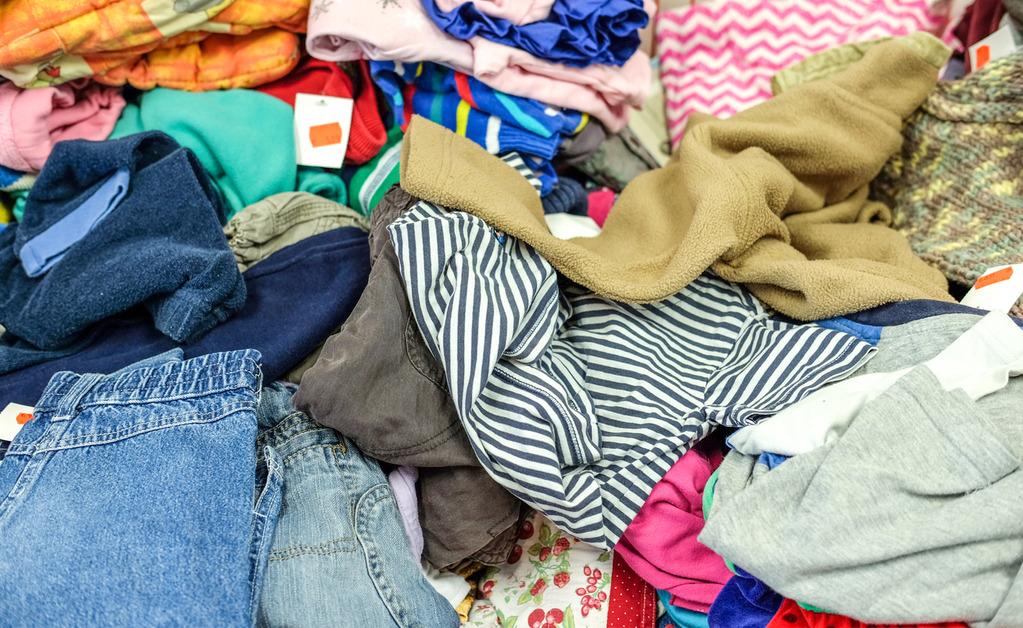 A close-up of a pile of clothing with reduced price tags. 