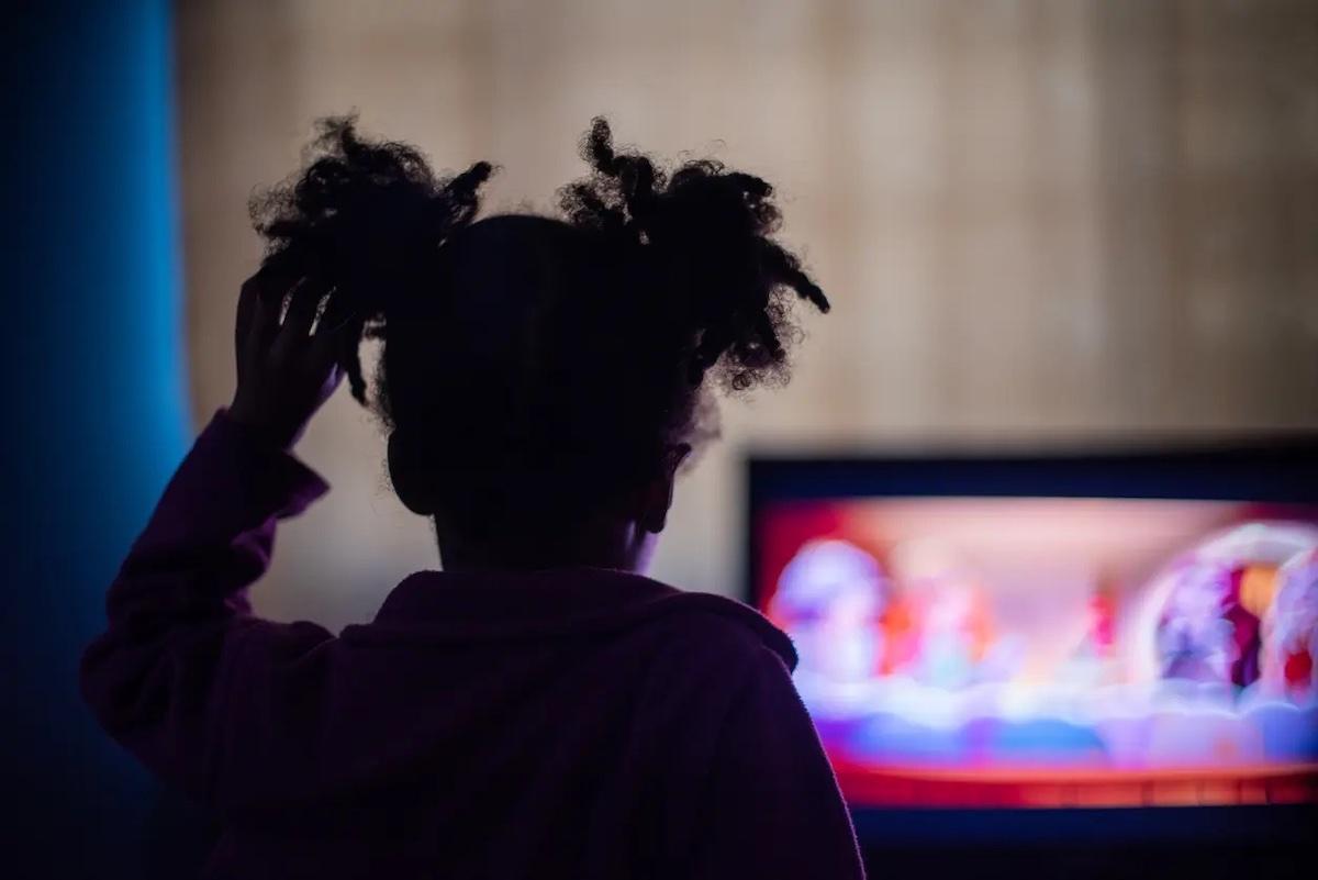 Silhouette of girl watching tv