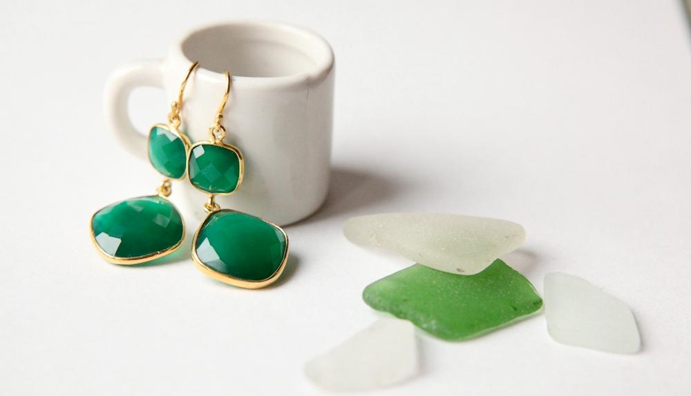 Green onyx earrings in a mug