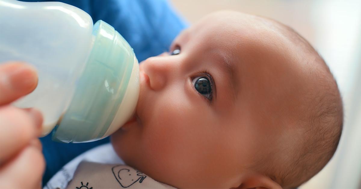 baby drinking from a baby bottle