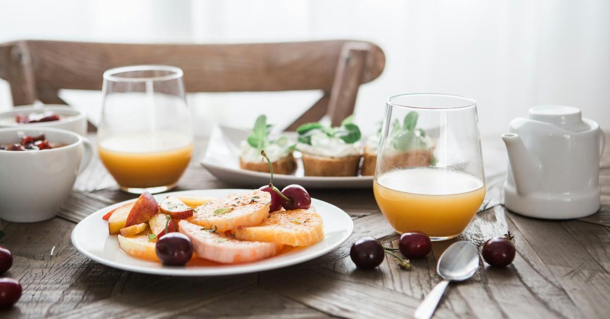 A breakfast plate is loaded with fruits