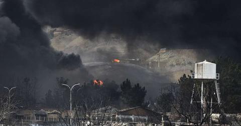 Plumes of smoke rise over the oil depot tanks that were hit in Tehran, Iran, on March 8, 2026. (Cover Image Source: Getty Images | Kaveh Kazemi)