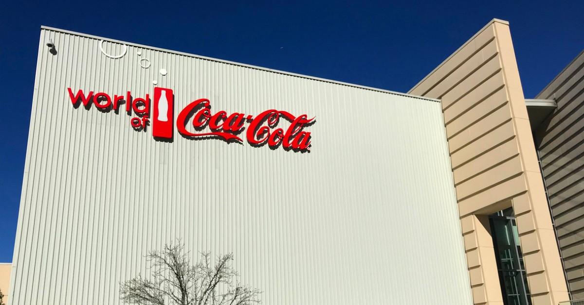 The Coca-Cola logo hangs on the front of one of the company's buildings