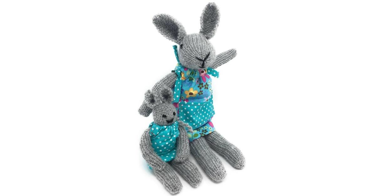 A knitted pair of a gray mom and baby bunny wearing blue pinafores.