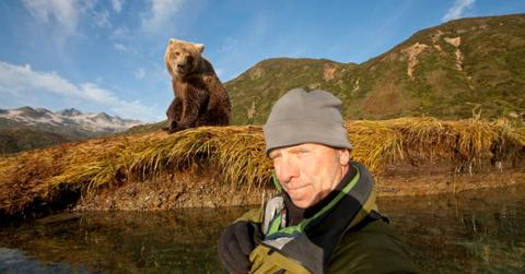 Self-portrait of a photographer standing near a young grizzly bear on an autumn morning along Kinak Bay (Representative Image Source: Getty Images | Paul Souders)