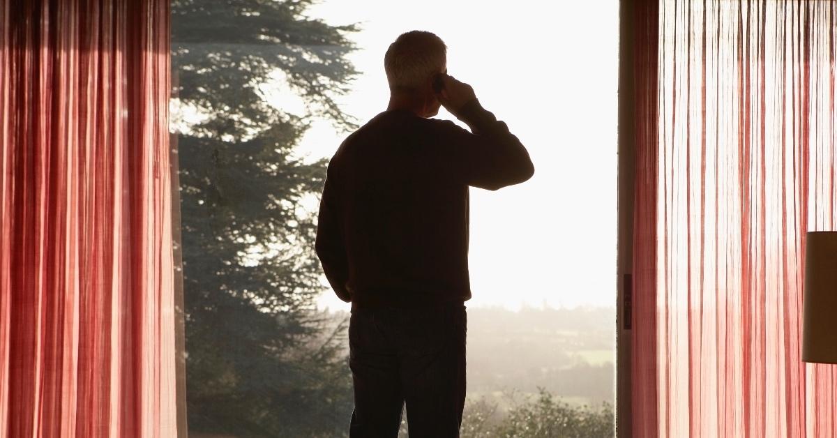 Man looking out window.