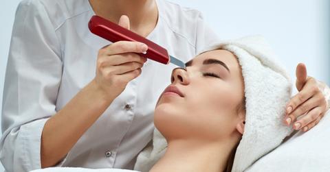 woman with closed eyes receiving dermaplaning treatment