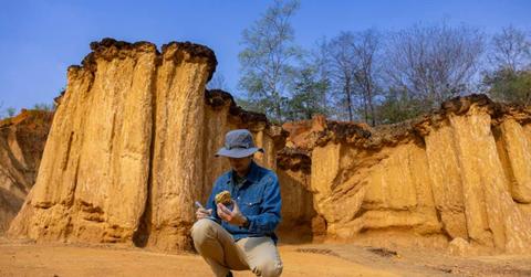 Scientist analyzing the rock with a tool (Representative Cover Image Source: Getty Images | Akarawut Lohacharoenvanich)