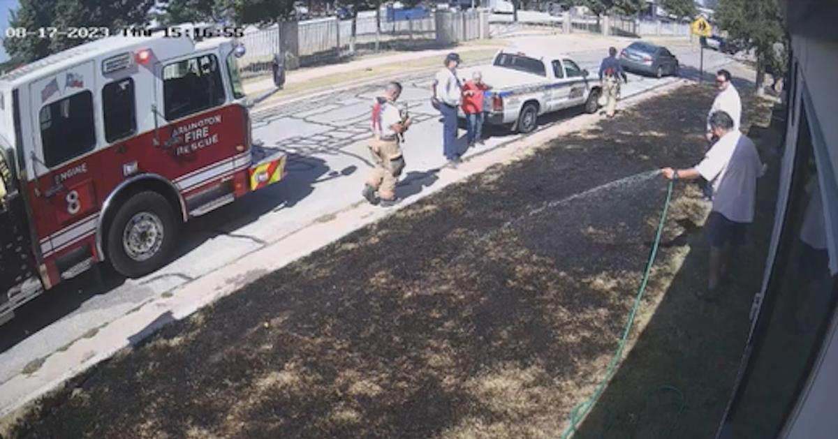 fire truck and people with hoses putting out lawn fire