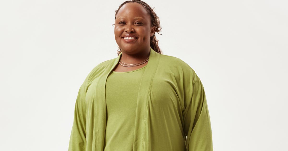 A woman wearing a green pajama set.