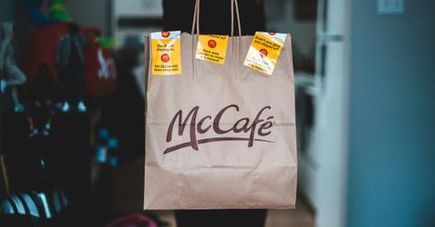 A McDonald's patron holds up a bag from the fast food chain