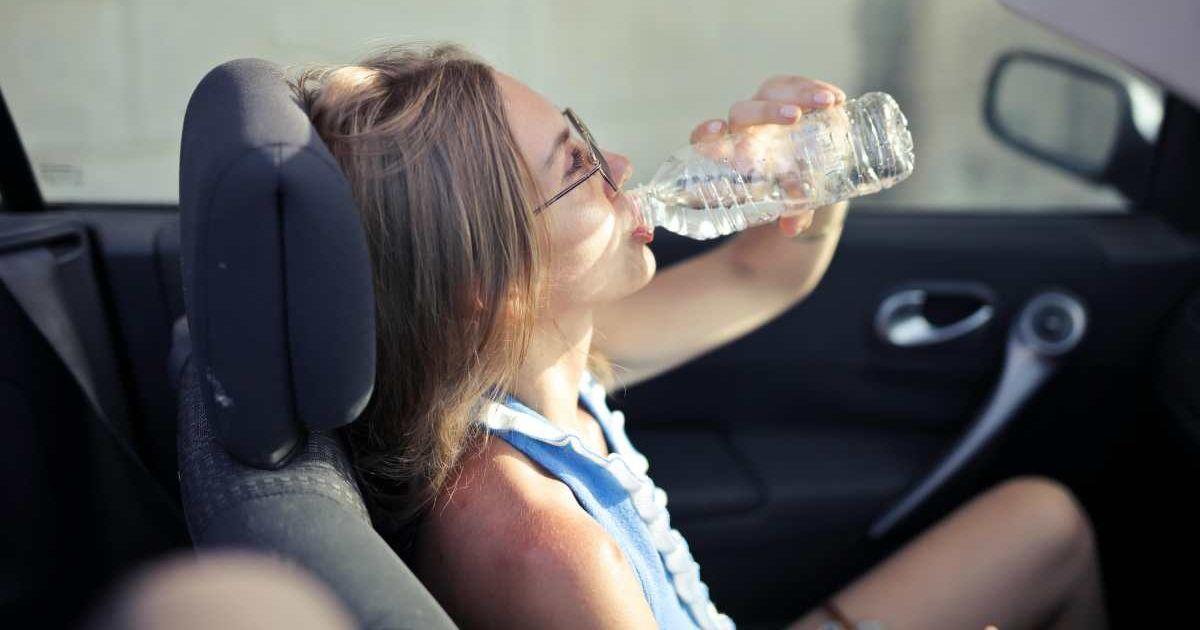 Female drinking water in a convertible car in city. (Representative Cover Image Source: Pexels | Andrea Piacquadio)