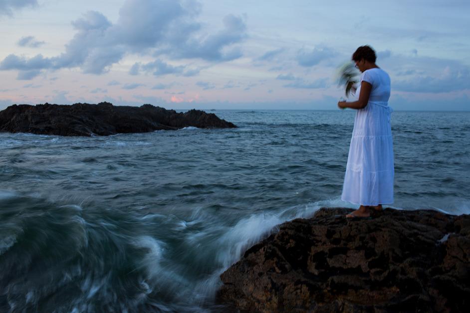 Woman standing next to water. 