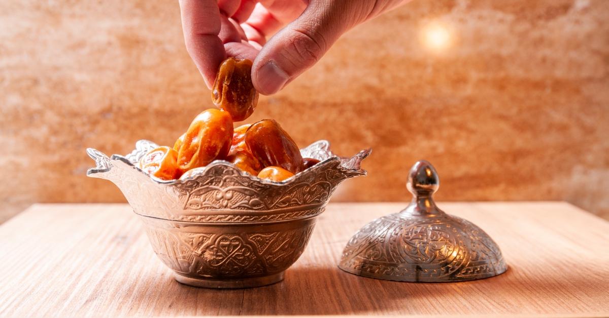 A person reaches for a date while fasting during Ramadan. 