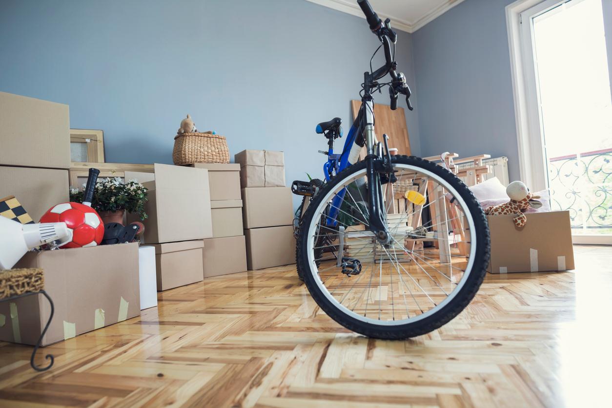 A bicycle is pictured beside brown boxes with donations inside them.