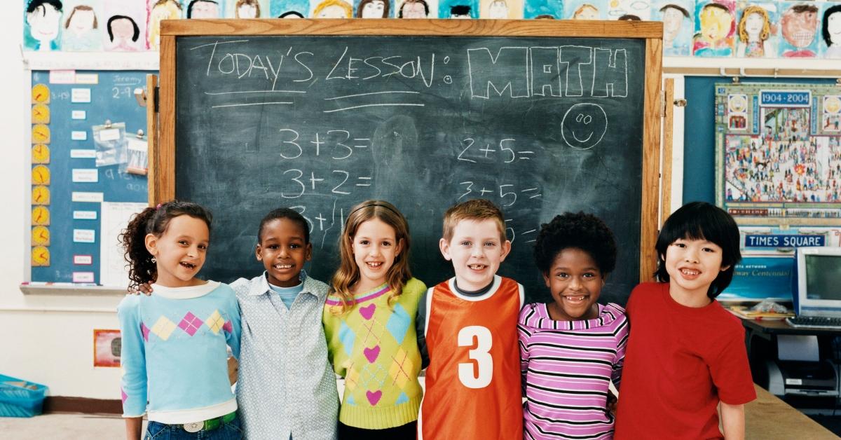 Six kids in a school classroom. 