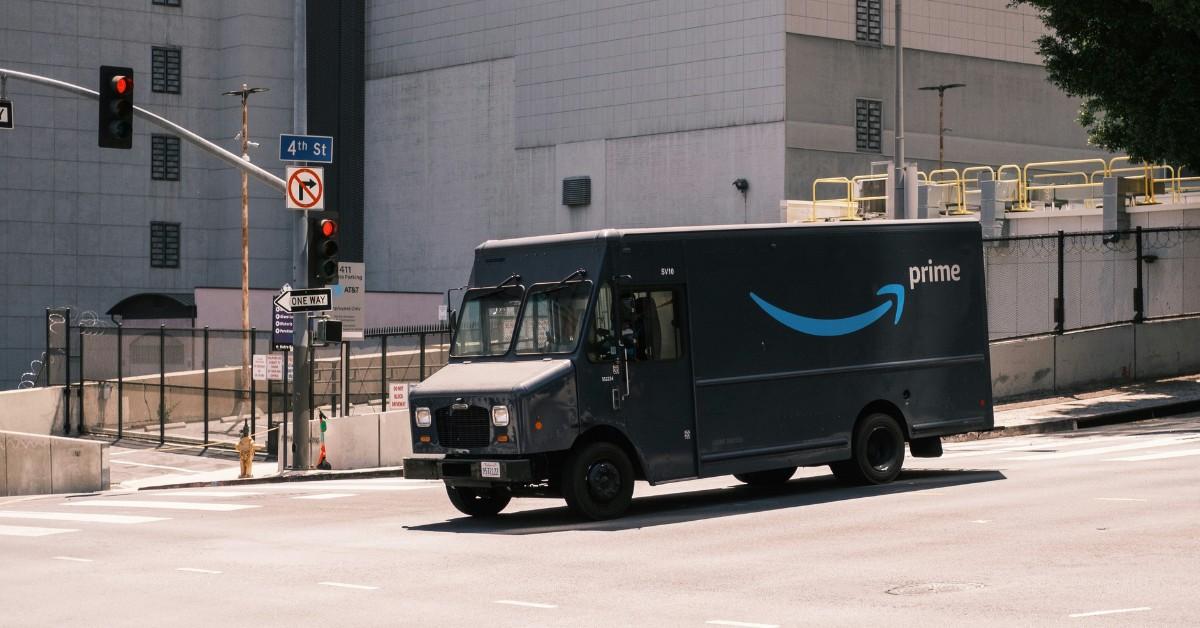 An Amazon truck drives down a city street
