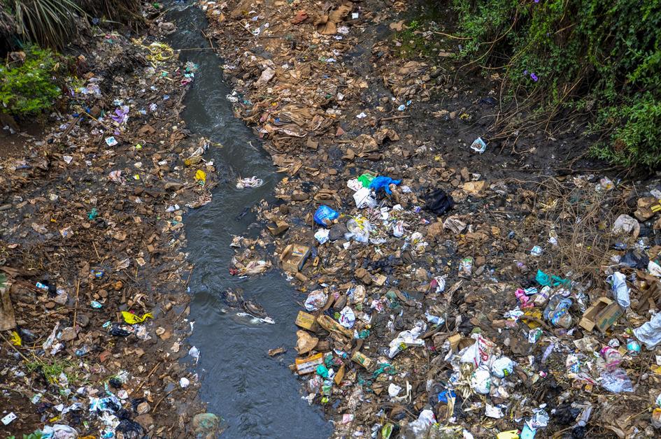 A view of the Nairobi River covered in trash. 