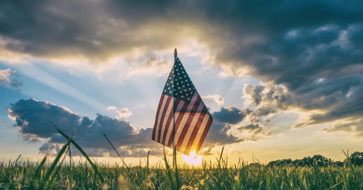 The sun sets on the American flag